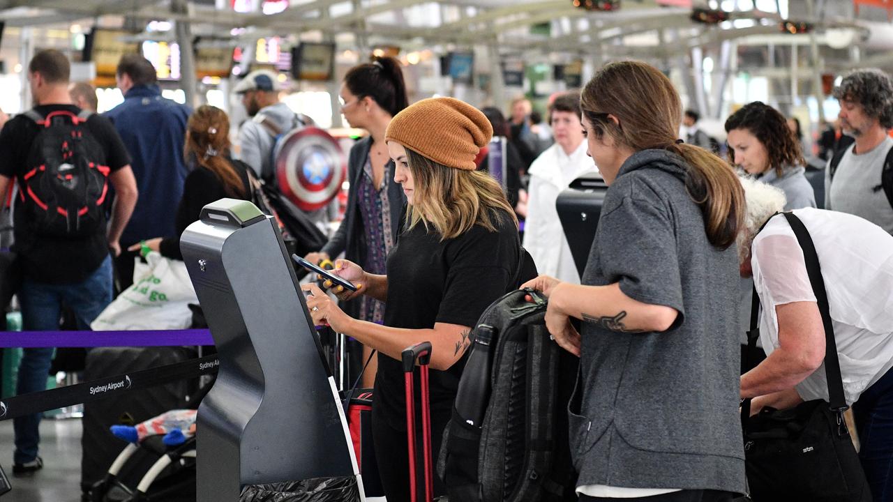 Passengers check in for flights despite long delays on Wednesday. Picture: AAP/Brendan Esposito