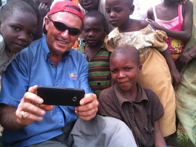 Bernie Scanlan in Uganda, with some of the children he’s helped. Pictures: Facebook