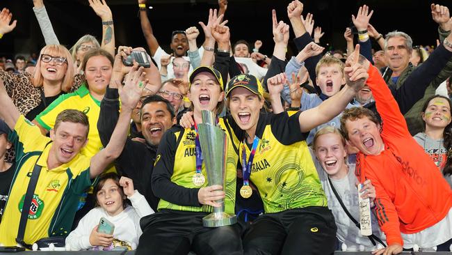 Rachael Haynes and Sophie Molineux of Australia celebrate with the trophy after winning the Women's T20 World Cup final. AAP Image/Scott Barbour