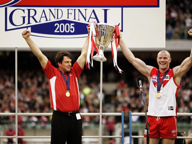 Coach Paul Roos and Barry Hall raise the cup after the Swans’ 2005 grand final victory.