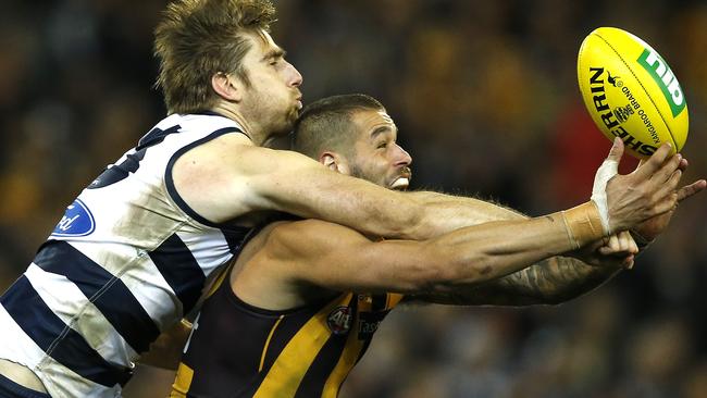 Tom Lonergan in classic defender mode, spoiling then-Hawk Lance Franklin.