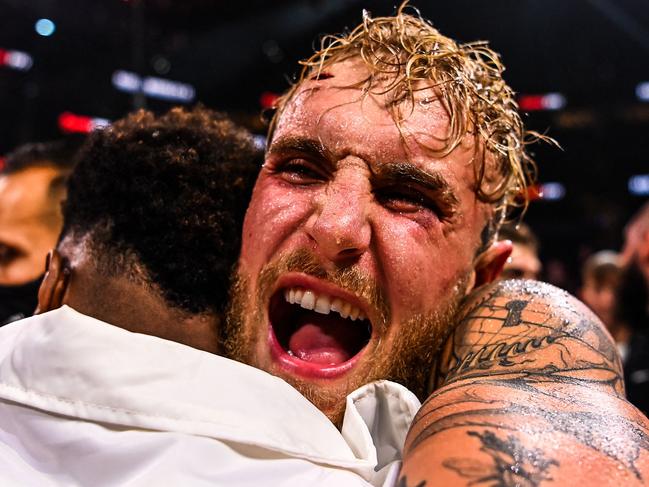 YouTube personality Jake Paul celebrates after knocking out former UFC welterweight champion Tyron Woodley during a fight at the Amalie Arena in Tampa, Florida, on December 18, 2021. (Photo by CHANDAN KHANNA / AFP)