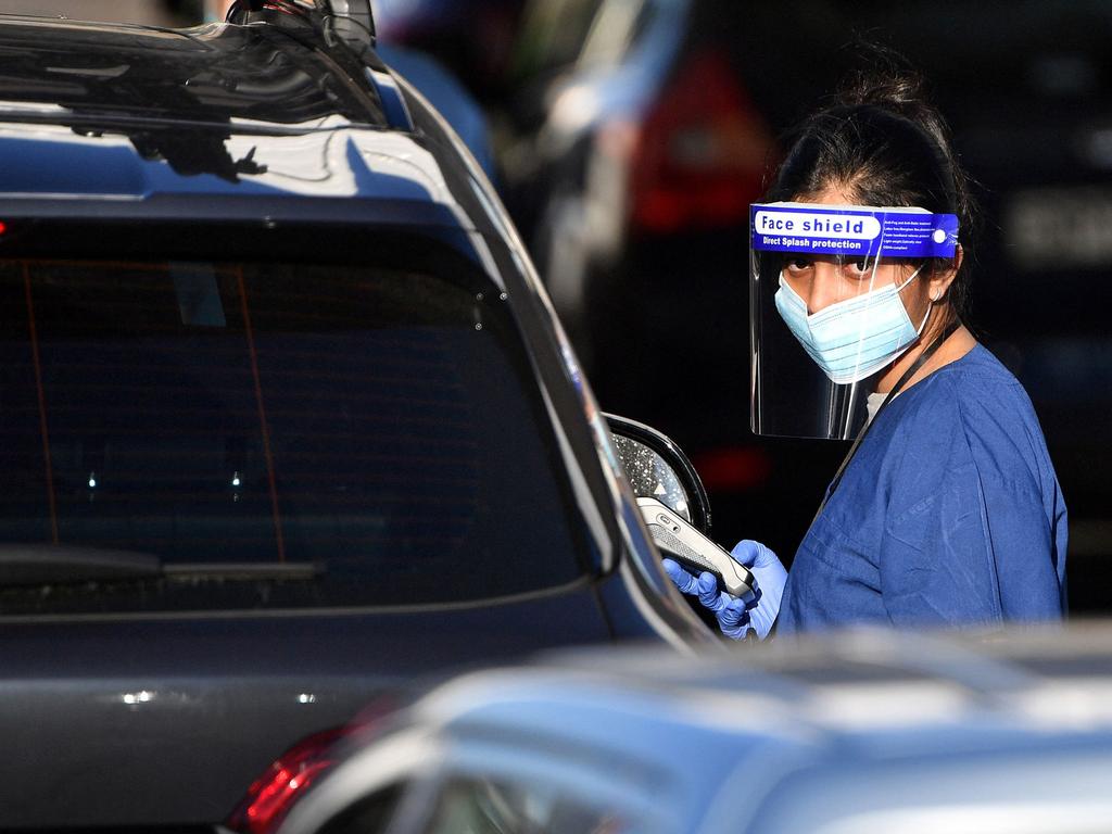 A health worker registers people for Covid-19 tests at a drive-through testing centre at Sydney’s Bondi Beach yesterday. Picture: Saeed Khan/AFP