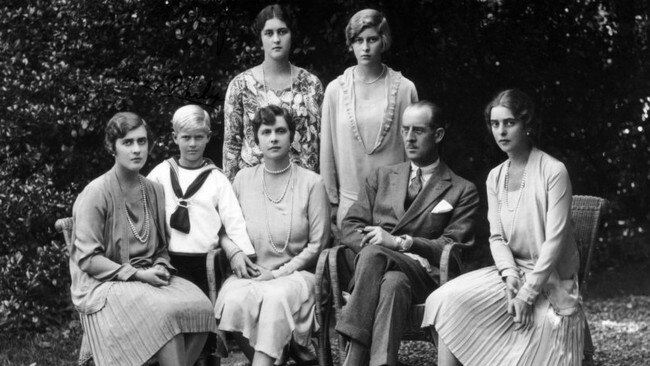 Prince Philip’s family, circa 1930. A young Prince Philip stands to the left of his mother, Princess Andrew (Alice of Battenberg) and Prince Andrew of Greece and Denmark (called Andrea). From left to right are Philip’s sisters, all Princesses of Greece and Denmark: Margarita, Theodora, Sophie, and Cecilie.