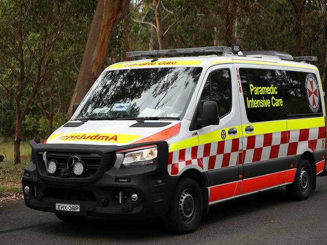 SYDNEY, AUSTRALIA - NewsWire Photos JANUARY 20, 2021: An ambulance passes by a police road block near Keith Longhurst Reserve near where a police search is underway on the Georges river for a 15-year-old teenage boy believed to have drowned while swimming.Picture: NCA NewsWire / Damian Shaw