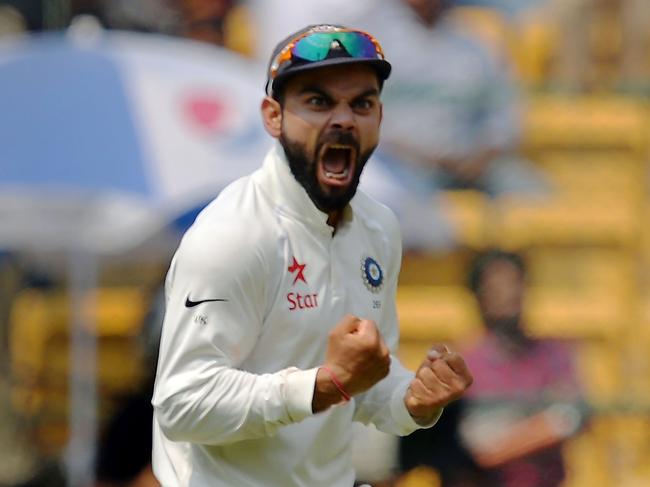 Indian cricket captain Virat Kohli celebrates the dismissal of Australian batsman Matthew Wade during the fourth day of the second cricket Test match between India and Australia at The M. Chinnaswamy Stadium in Bangalore on March 7, 2017. ----IMAGE RESTRICTED TO EDITORIAL USE - STRICTLY NO COMMERCIAL USE----- / GETTYOUT / AFP PHOTO / Manjunath KIRAN / ----IMAGE RESTRICTED TO EDITORIAL USE - STRICTLY NO COMMERCIAL USE----- / GETTYOUT