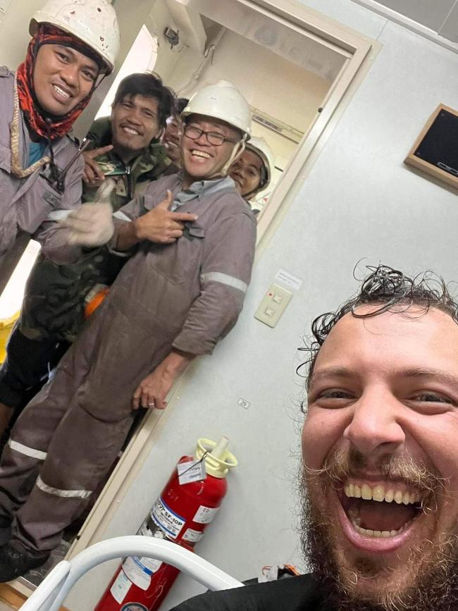 Gold Coast sailor Xavier Doerr with his rescuers aboard container ship Theodore JR. Picture: The Little Aussie Lap / Facebook