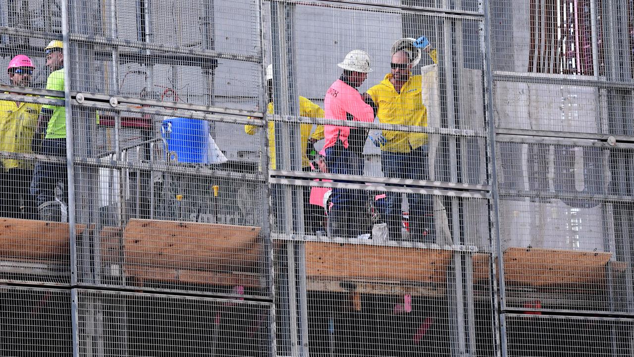 Workers are seen at a construction site in Brisbane.