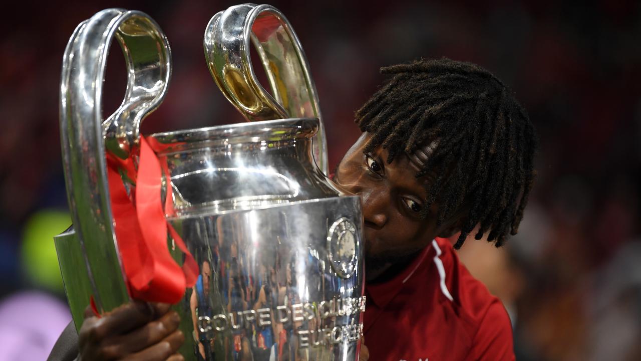 Divock Origi celebrates with the Champions League trophy.