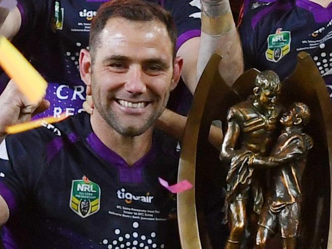 Cameron Smith (left) and Billy Slater of the Melbourne Storm team pose with the winners trophy after the NRL grand final between the Melbourne Storm and the North Queensland Cowboys at ANZ Stadium in Sydney, Sunday, October 1, 2017. (AAP Image/David Moir) NO ARCHIVING, EDITORIAL USE ONLY