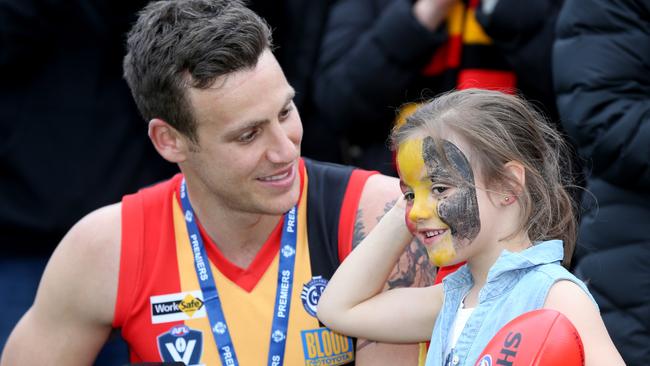 Daniel Measures and his daughter Never, after St Joseph’s 2018 premiership. Picture: Mike Dugdale