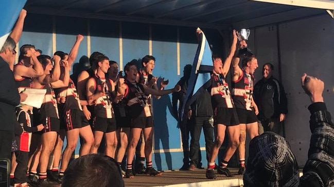 Millicent players celebrate after winning a thriller to claim the 2018 WBFL premiership.