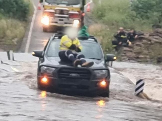 A 48 year old man took refuge on his car bonnet after being inundated by floodwaters outside Nebo. Photo: QFES