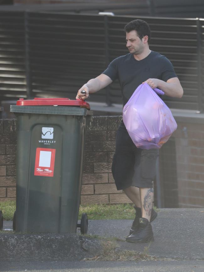 Koletti, a freelance hairdresser, takes the rubbish out at his simple new unit. Picture John Grainger