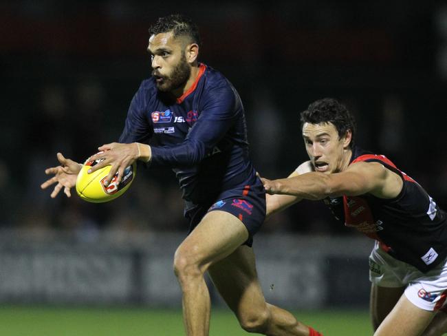 SANFL: Norwood v West Adelaide at Norwood Oval. Norwood's Dominic Barry escapes a lunging Thomas Keough for West. 31 May 2019. Picture Dean Martin