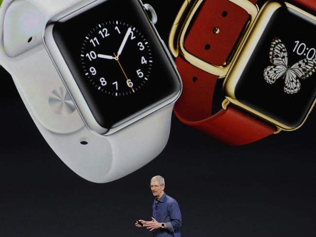 Tim Cook, chief executive officer of Apple Inc., unveils the Apple Watch during a product announcement at Flint Center in Cupertino, California, U.S., on Tuesday, Sept. 9, 2014. Apple Inc. unveiled redesigned iPhones with bigger screens, overhauling its top-selling product in an event that gives the clearest sign yet of the company's product direction under Cook. Photographer: David Paul Morris/Bloomberg *** Local Caption *** Tim Cook