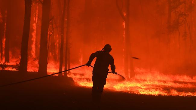 Firefighters protect a home being impacted by the Gospers Mountain fire near Colo Heights south west of Sydney on November 19. Picture: AAP