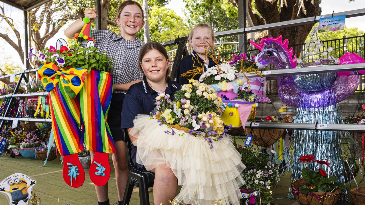 At the Toowoomba East State School hanging basket display are students (from left) Grace Simpson (holding winning student entry by Carter Simpson), Addyson Riddle (holding winning adult entry by Lydia Wade) and Matilda McGaw, Friday, September 13, 2024. Picture: Kevin Farmer