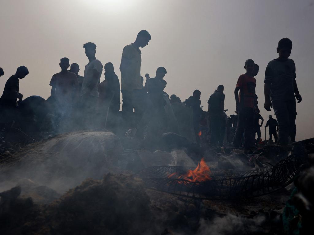 Palestinians gather at the site of an Israeli strike on a camp for internally displaced people in Rafah on May 27, 2024. (Photo by Eyad BABA / AFP)