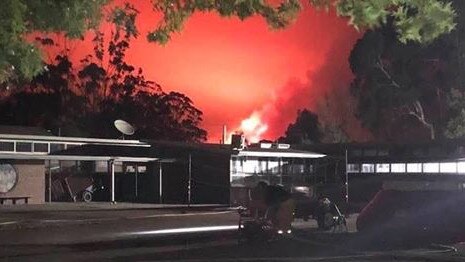 A fire can be seen raging behind the Cann River school. Picture: Robert Puyenbroek