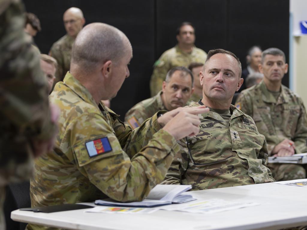 Director of Exercise Talisman Sabre 2023, Brigadier Damian Hill, briefs Commanding General Major General Jered Helwig and Command Sergeant Major Frank M. Graham Jr of the United States Army's 8th Theater Sustainment Command on planning for Exercise Talisman Sabre 2023.