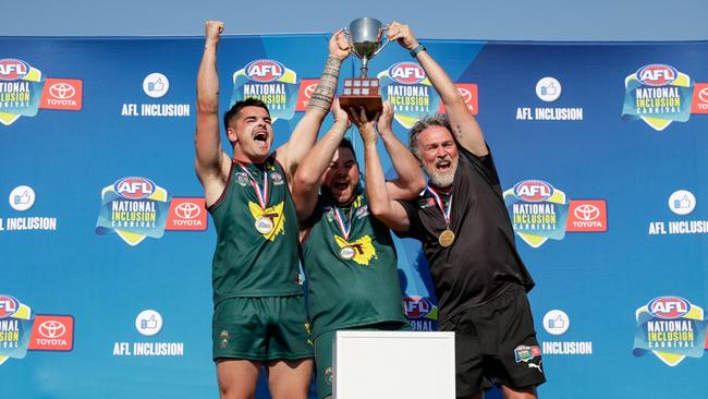 SPRINGFIELD, AUSTRALIA – OCTOBER 13: Tasmanian co-captains Craig Blaschke, Justin Nilon and coach Darrin Geard celebrate the win over SA. (Photo by Russell Freeman/AFL Photos via Getty Images)