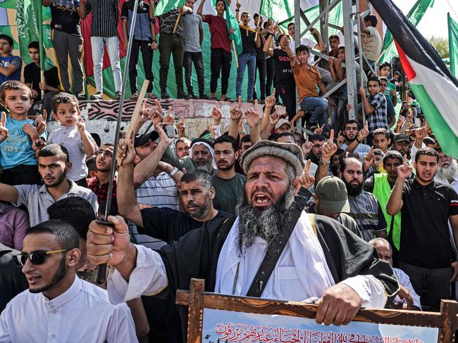 Supporters of the Palestinian Hamas movement lift national flags during a rally against Israel this month. Picture: AFP