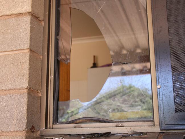 A broken window at a home on Hibiscus St, Eastside, Alice Springs, Wednesday December 19, 2024. In the home lives 87-year-old Margaret Moore, who has Alzheimer's, and her carer Meloni Lambert, who say they were broken into again the day before. It marks the fifth time in two years Mrs Moore's home has been broken into. Picture: Gera Kazakov