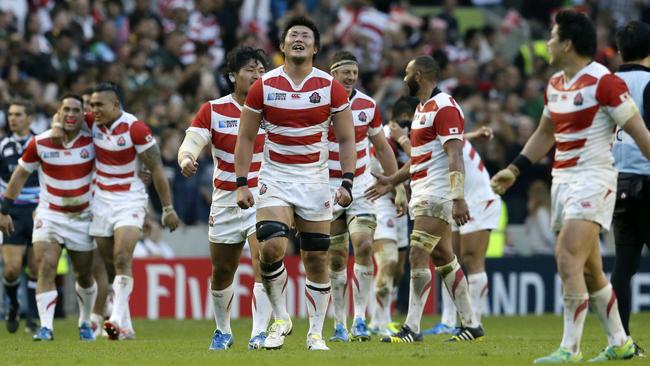 Japan players celebrate defeating South Africa 32-34 in the Rugby World Cup Pool B match at the Brighton Community Stadium, Brighton, England Saturday, Sept. 19, 2015. (AP Photo/Tim Ireland)