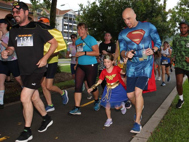 Scott Lane and his daughter Indi Lane, 4, dress as Wonder Woman and Superman in the Cairns Regional Council's New Year's Eve superhero fun run on the Cairns Esplanade. Picture: Brendan Radke