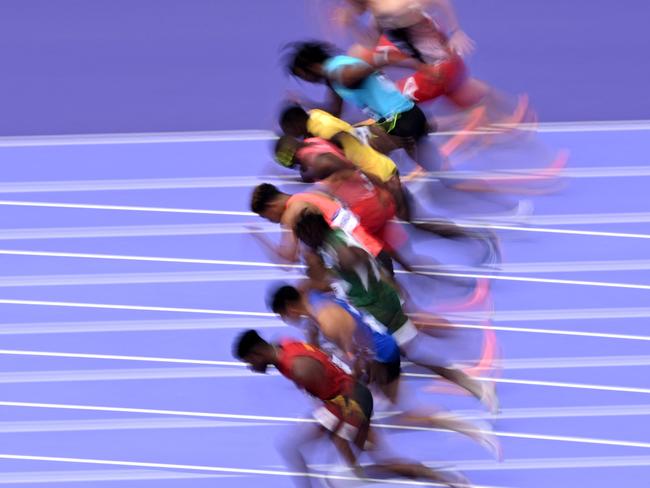 TOPSHOT - Athletes competes in the men's 100m heat of the athletics event at the Paris 2024 Olympic Games at Stade de France in Saint-Denis, north of Paris, on August 3, 2024. (Photo by Kirill KUDRYAVTSEV / AFP)