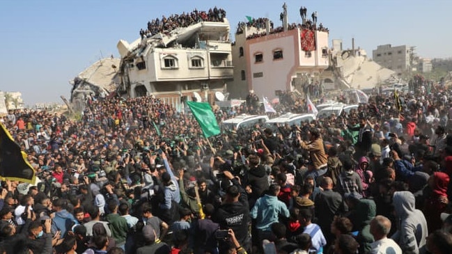 A crowd gathered Thursday outside the Gaza home of a slain Hamas leader to watch the release of hostages. Picture: Naaman Omar/Apaimages/Zuma Press