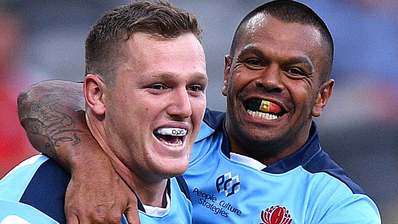 Waratahs star Kurtley Beale celebrates with tryscorer Angus Bell.