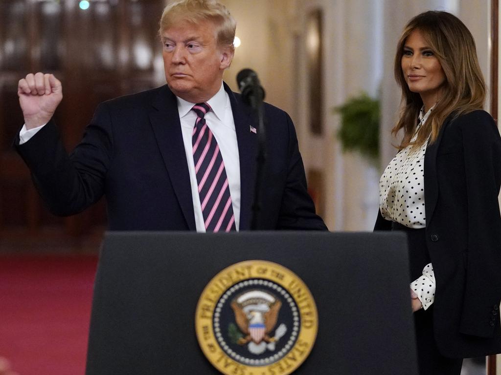 President Donald Trump gestures as he speaks at the White House, as first lady Melania Trump looks on. Picture: AP