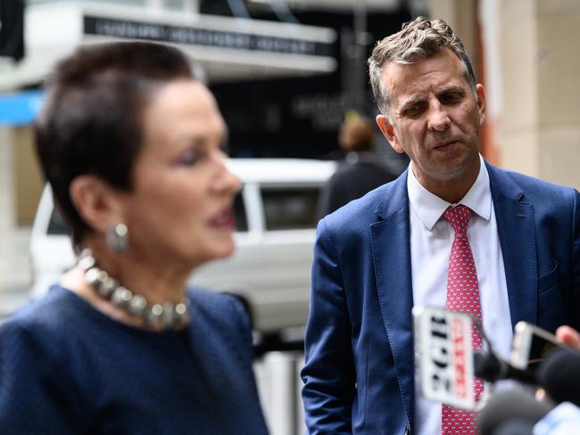 NSW Minister for Transport Andrew Constance watching on as Sydney Lord Mayor Clover Moore announces the temporary cycleways. (AAP Image/James Gourley) NO ARCHIVING