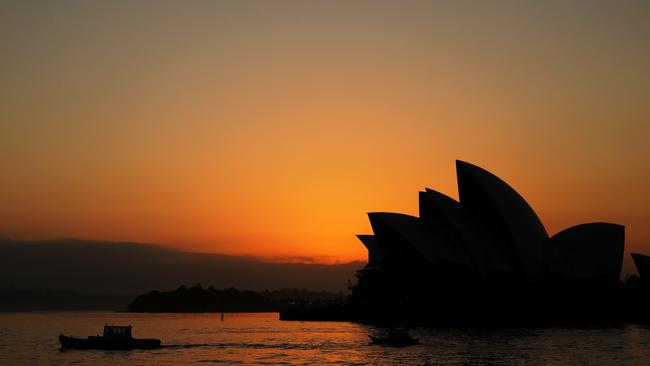 Another hot day is forecasted for Sydney as the sun rises over the Opera House. Picture John Grainger