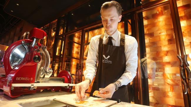 John Aubert, retail assistant, slicing meat at the charcuterie counter. Picture Yuri Kouzmin