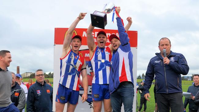 Jake Bridges (right) lifts the premiership cup after winning the 2019 grand final. Picture: Red Photos / Adam Cornell.