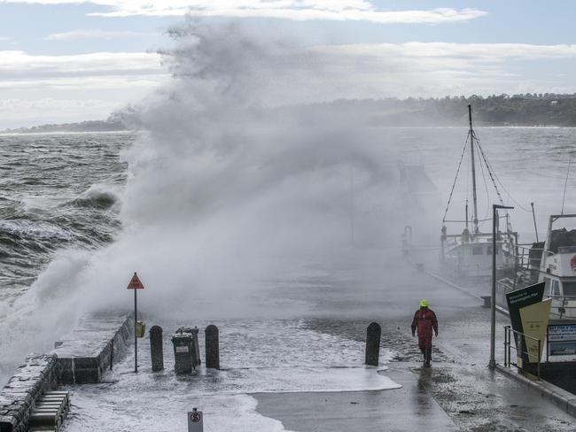 A man walks onto Mornington Pier as heavy winds cause massive waves. Photo taken on the 3rd of May, 2016. Picture: Christopher Chan.