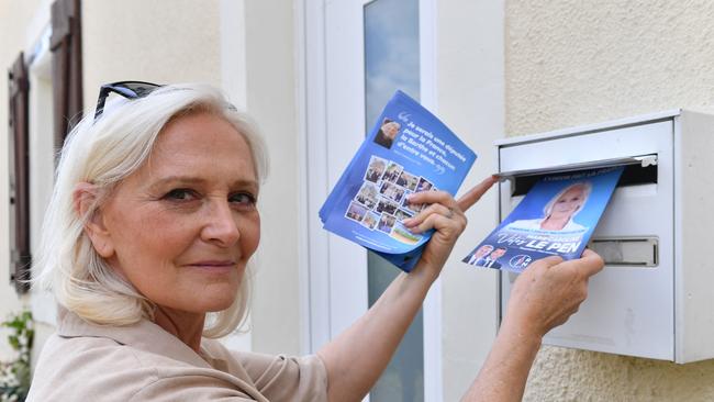 French far-right National Rally (RN) party member and candidate for the second round of legislative elections Marie-Caroline Le Pen, places political campaign leaflets in a mailbox. Picture: AFP