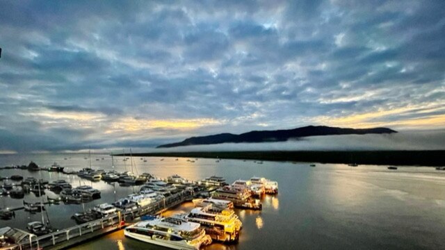 Cairns weather: After four straight days of heavy April rain, the sun is shining again, through clouds, over the Cairns Marlin Marina. Picture: Anne Massey