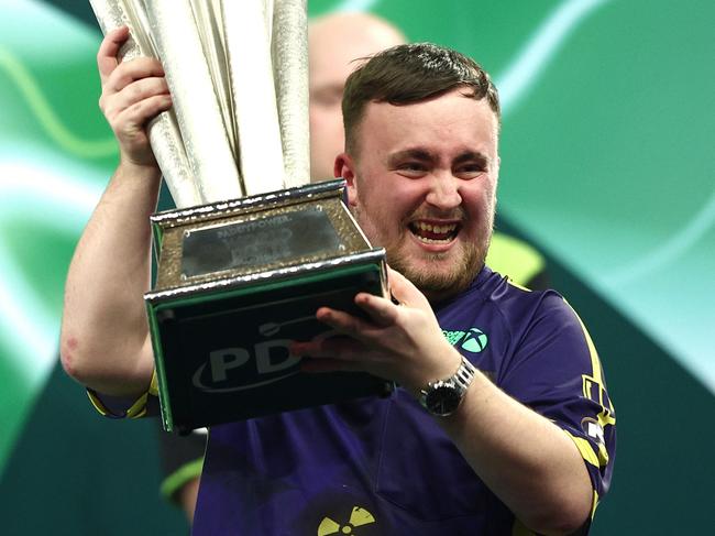 LONDON, ENGLAND - JANUARY 03: Luke Littler of England lifts the trophy as he celebrates winning the Final against Michael van Gerwen of The Netherlands during day sixteen of the 2024/25 Paddy Power World Darts Championship at Alexandra Palace on January 03, 2025 in London, England. (Photo by James Fearn/Getty Images)