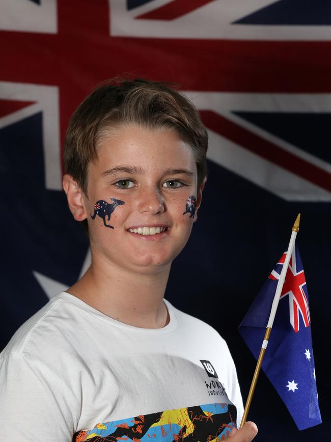 Retailers no longer sell Australia Day merch, like the flag Ben Stanley, 10, was proudly waving in 2014.