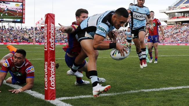 Valentine Holmes scores one of his three tries for the Sharks.