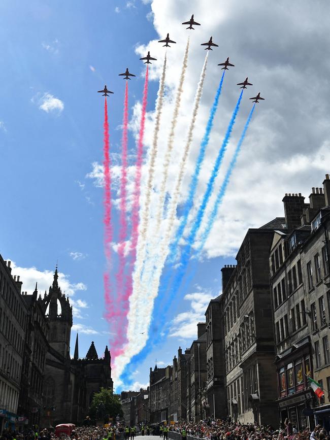 The Royal Air Force's Red Arrows perform a fly-past over The Royal Mile in Edinburgh. (Photo by Mark Runnacles / POOL / AFP)