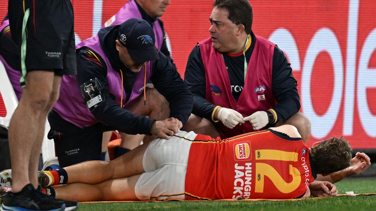 MELBOURNE, AUSTRALIA - JULY 19: Jordan Dawson of the Crows receives medical attention during the round 19 AFL match between Essendon Bombers and Adelaide Crows at Marvel Stadium, on July 19, 2024, in Melbourne, Australia. (Photo by Daniel Pockett/Getty Images)