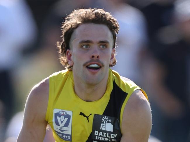 MELBOURNE, AUSTRALIA - AUGUST 25: Tom McCarthy of the Tigers handpasses the ball during the 2024 VFL Wildcard Round match between Williamstown and Richmond at DSV Stadium on August 25, 2024 in Melbourne, Australia. (Photo by Rob Lawson/AFL Photos)