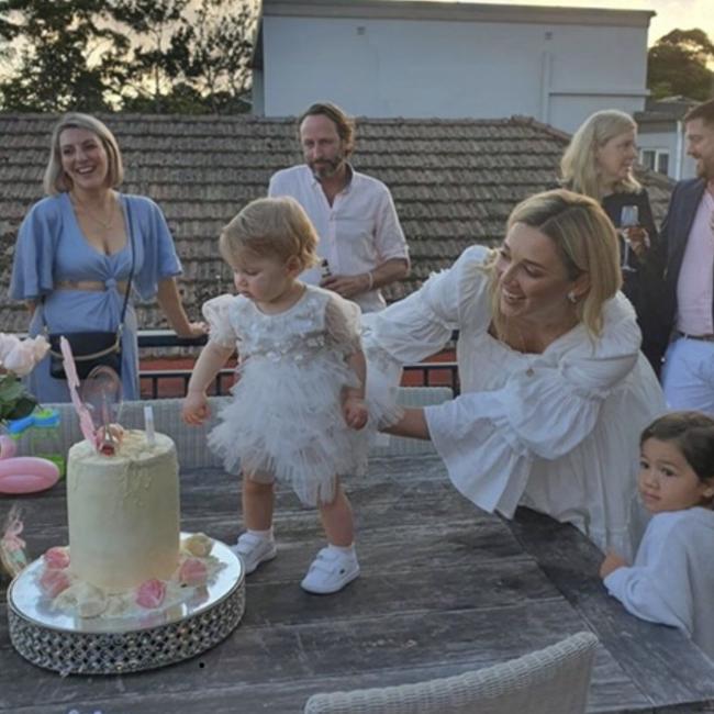 Harper takes a closer look at her birthday cake, with a little help from Mummy. Picture: Instagram