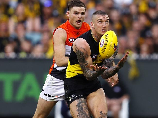 Dustin Martin marks on the lead infant of GWS Giants Heath Shaw. Pic: Michael Klein