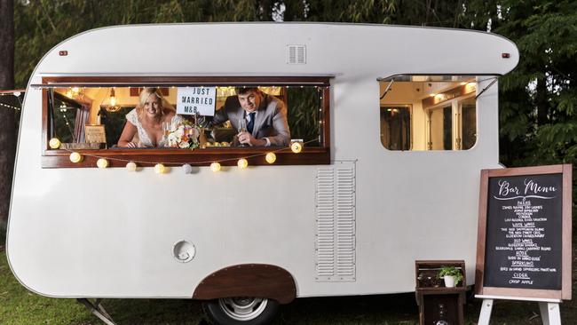 Vintage fun: Matthew Brunes and Bridget Williams in the caravan. Picture: iSpy Wedding Photography (Dylan Evans)